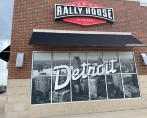 Installing commercial signage of Rally House Detroit